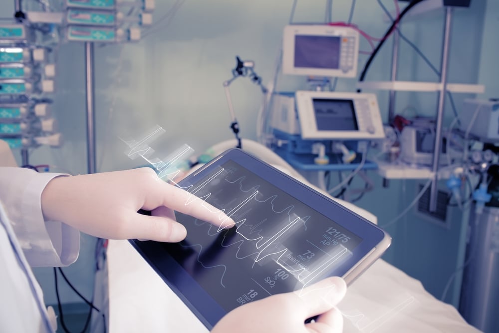 Physician working on tablet in hospital room