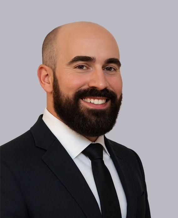 Professional headshot of Dr. Breitbart, MD, FAAOS, wearing a dark suit and tie, smiling against a light gray background.