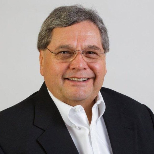 Professional head shot of Randall S. Barko wearing a dark suit and smiling against a light gray background.