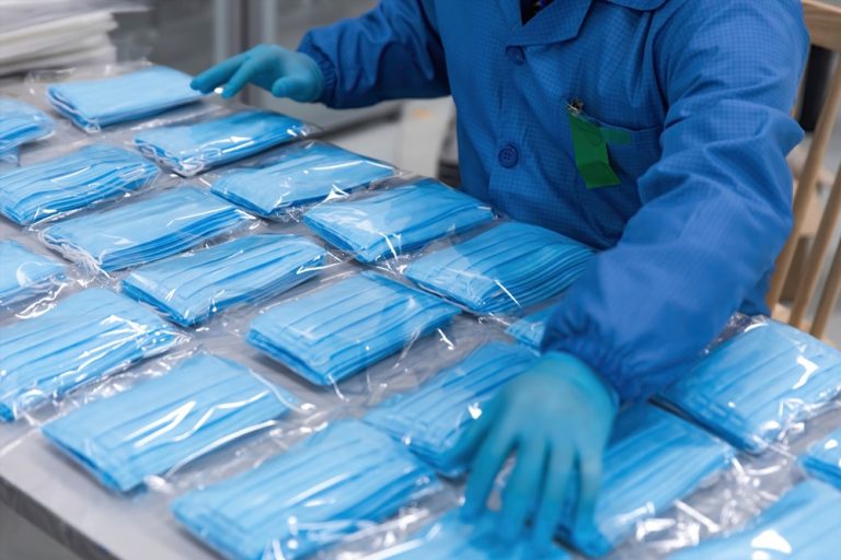 Physician organizing single use surgical masks.