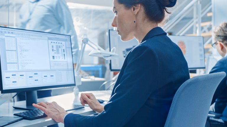Medical professional on the computer analyzing medical device software.