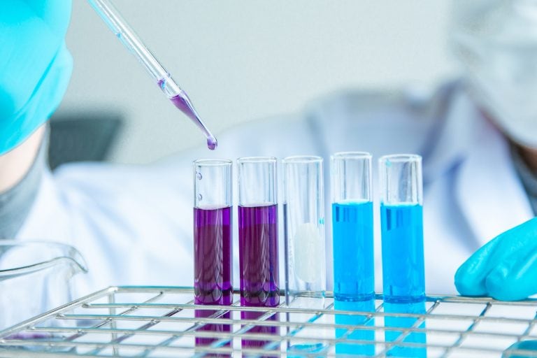 Medical professional in lab testing using in vitro diagnostics.