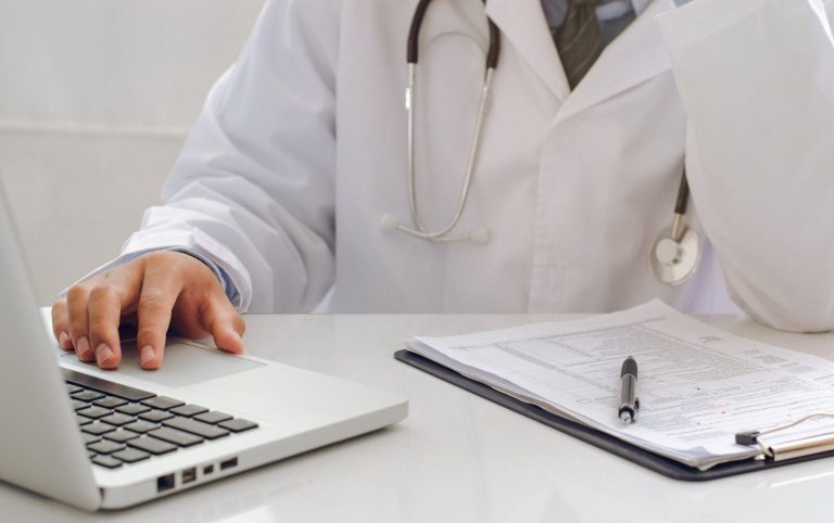 Doctor researching medical device information.