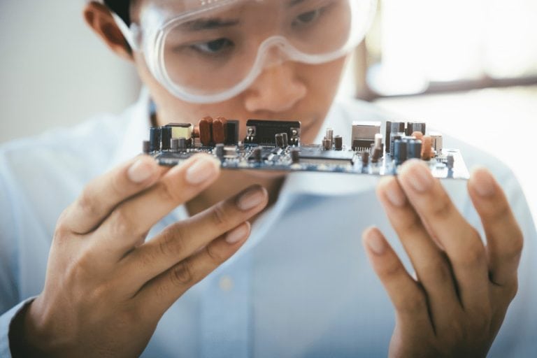 person holding a circuitboard