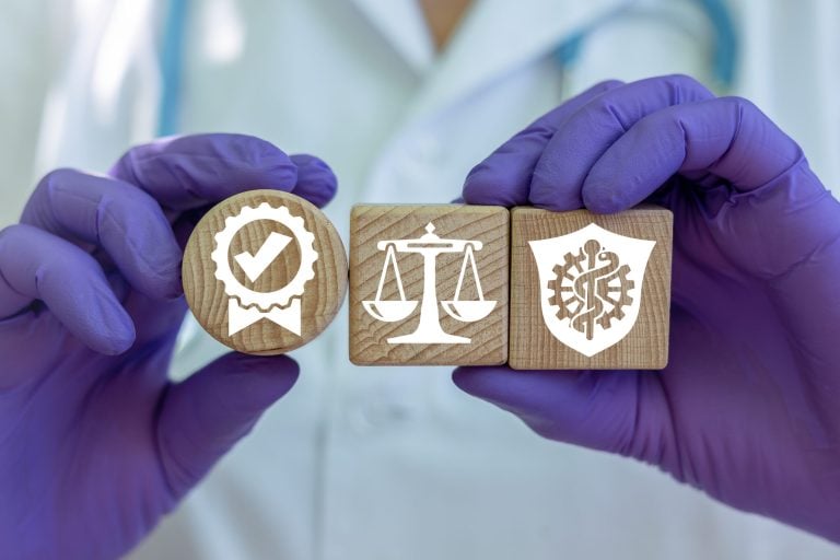 Medical professional holding medical quality assurance icons