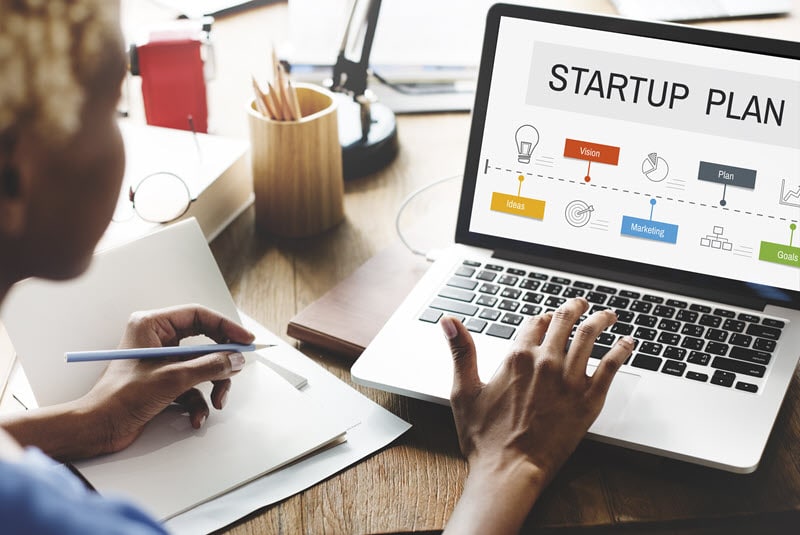 A woman works on a plan for medical device startup companies