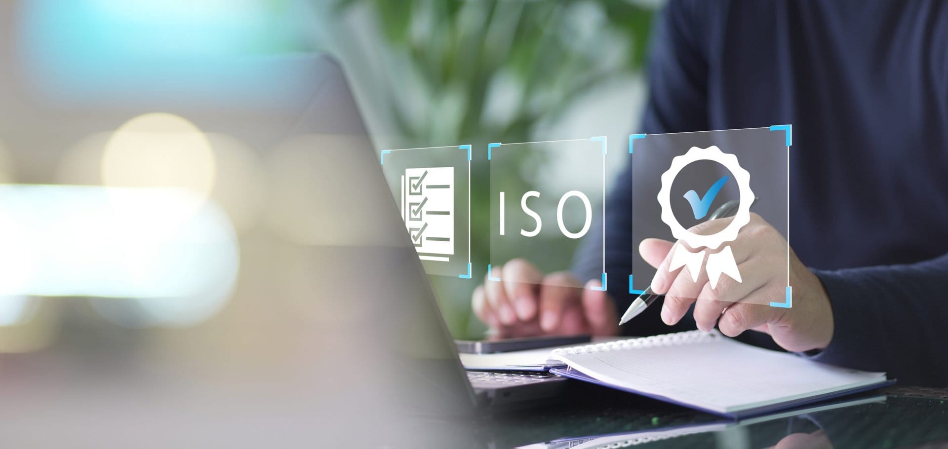 Professional on computer reviewing ISO documents.